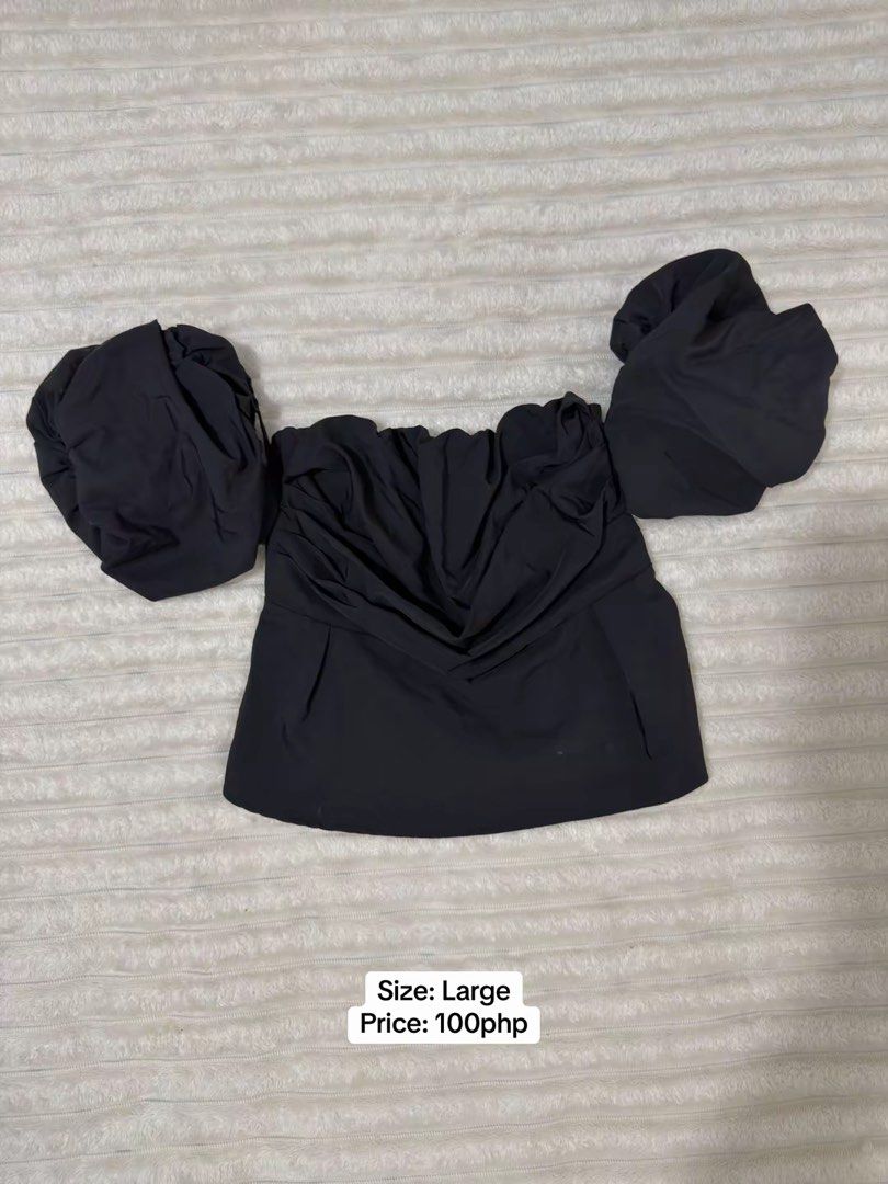 Black Off-Shoulder Puff Sleeve Top Size Large (Category: Blouses) located in Pasig City. Submitted by jamie.sebuc (Listing ID 1465237725, Image 1). Description: - Color: Black - Size: Large - Style: Off-shoulder with dramatic puff sleeves and ruched front - Fabric: Smooth and lightweight - Perfect for: Date nights, weekend brunch, or casual outings.