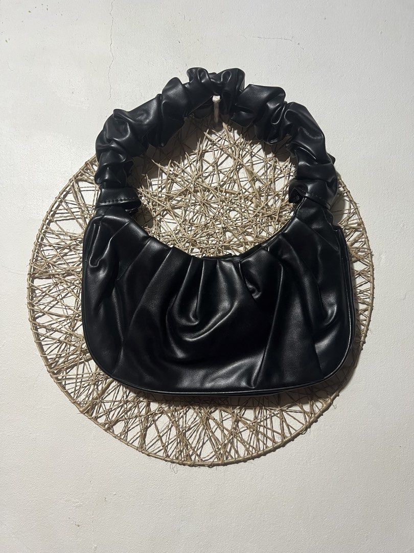 Black Ruched Shoulder Bag (Category: Shoulder Bags) located in Pasig City. Submitted by ilmsf (Listing ID 1465173165, Image 1). Description: - Color: Classic Black - Material: Soft and durable faux leather - Design: Trendy gathered, crinkled texture with a comfortable scrunched top handle and clean stitching - Closure: Secure top zipper - Capacity: Perfectly fits small daily essentials like your phone, keys, and cards - Condition: Brand new / Exc