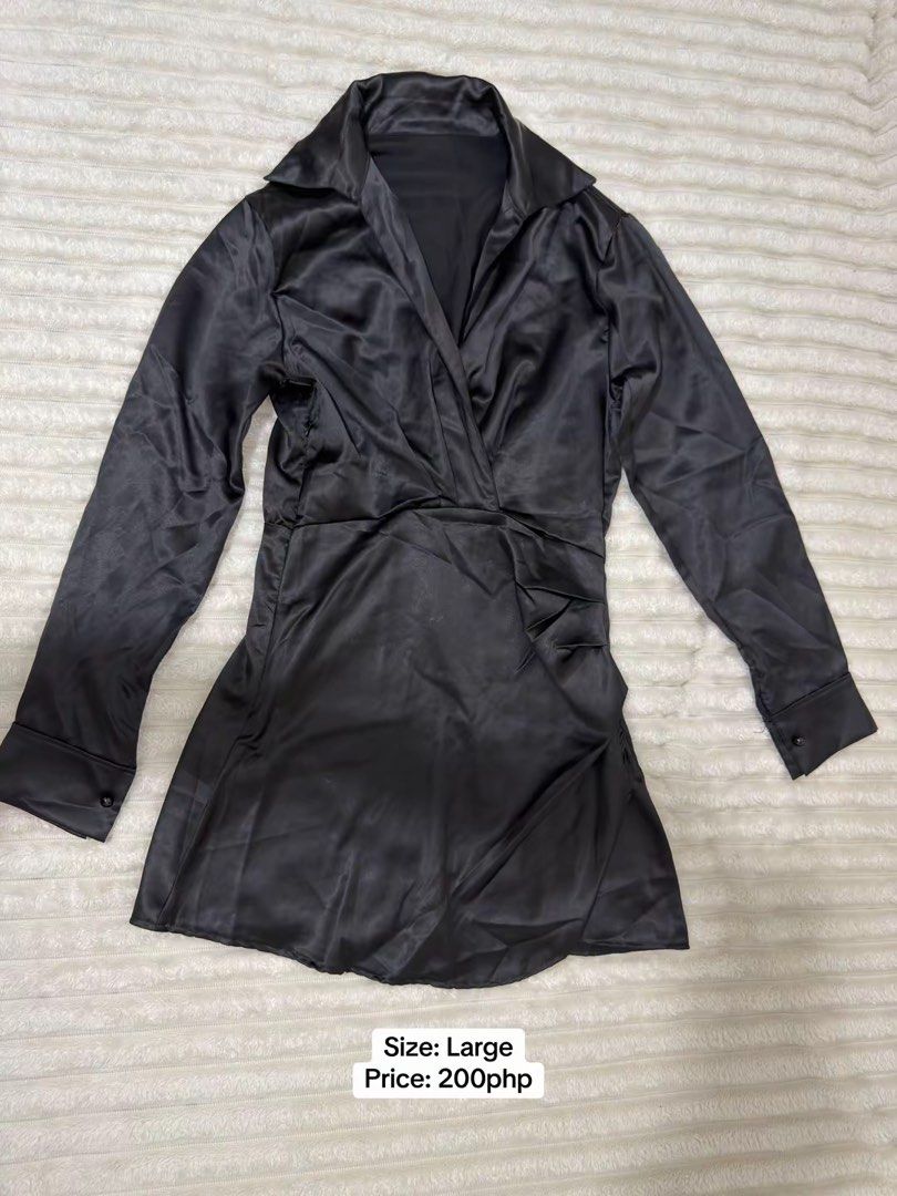 Black Satin Long Sleeve Collared Mini Dress (Category: Dresses) located in Pasig City. Submitted by jamie.sebuc (Listing ID 1465237745, Image 1). Description: - Color: Black - Material: Smooth satin with a slight sheen - Size: Large - Price: 200php - Features: Long sleeves with button cuffs, pointed collar, wrap-style front, and stylish gathered side detailing.