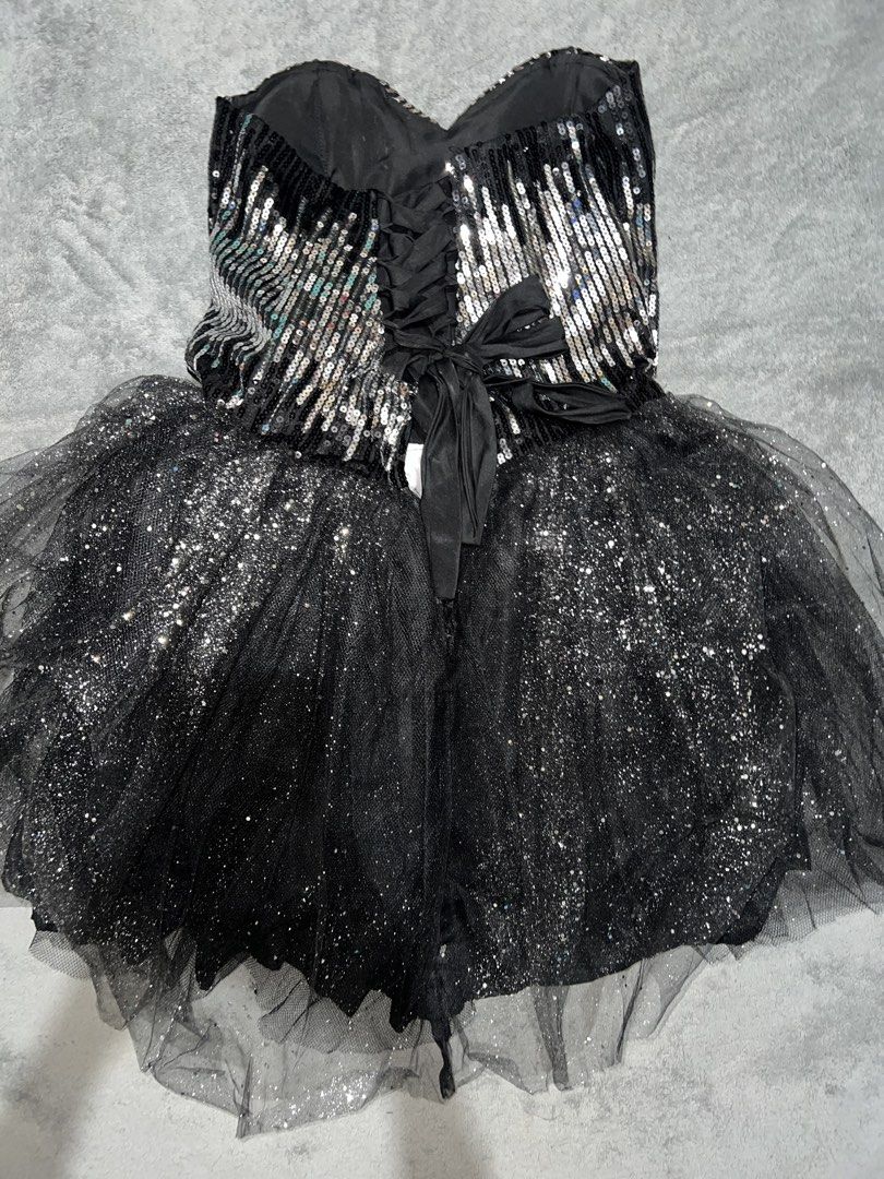 Black Sequins Tulle Strapless Cocktail Dress (Category: Dresses) located in Cainta. Submitted by dyclutterxoxo (Listing ID 1465333385, Image 2). Description: - Style: Black strapless party romper - Bodice: Shimmering silver sequins with a flattering sweetheart neckline - Bottoms: Fluffy tulle overlay with glitter sparkles covering the shorts - Back Details: Adjustable lace-up corset back with a satin ribbon tie closure - Perfect For: Parties, nig