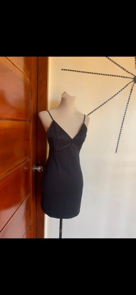 Black Spaghetti Strap Bodycon Mini Dress (Category: Dresses) located in Manila. Submitted by spaceshop12345 (Listing ID 1465309536, Image 2). Description: - Color: Black - Style: Bodycon fit, hits above the knee - Details: V-neckline with mesh cutouts under the bust - Straps: Thin, adjustable spaghetti straps - Condition: Clean and ready to wear - Perfect for: Nights out, parties, and date nights.