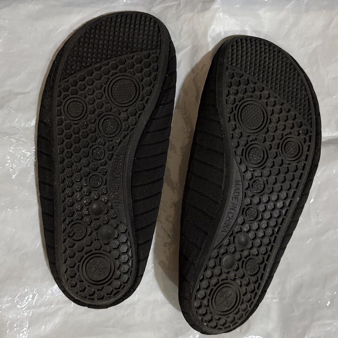 Black Swimming Shoes (Category: Slippers and slides) located in Makati City. Submitted by julyco. (Listing ID 1465360168, Image 2). Description: - Color: Black - Size: 36/37 (printed on soles) - Style: Slip-on with heel pull tabs for easy wear - Traction: Textured soles provide great grip on wet surfaces - Portability: Flexible material packs down small for travel - Best for: Beach, pool, and water sports.
