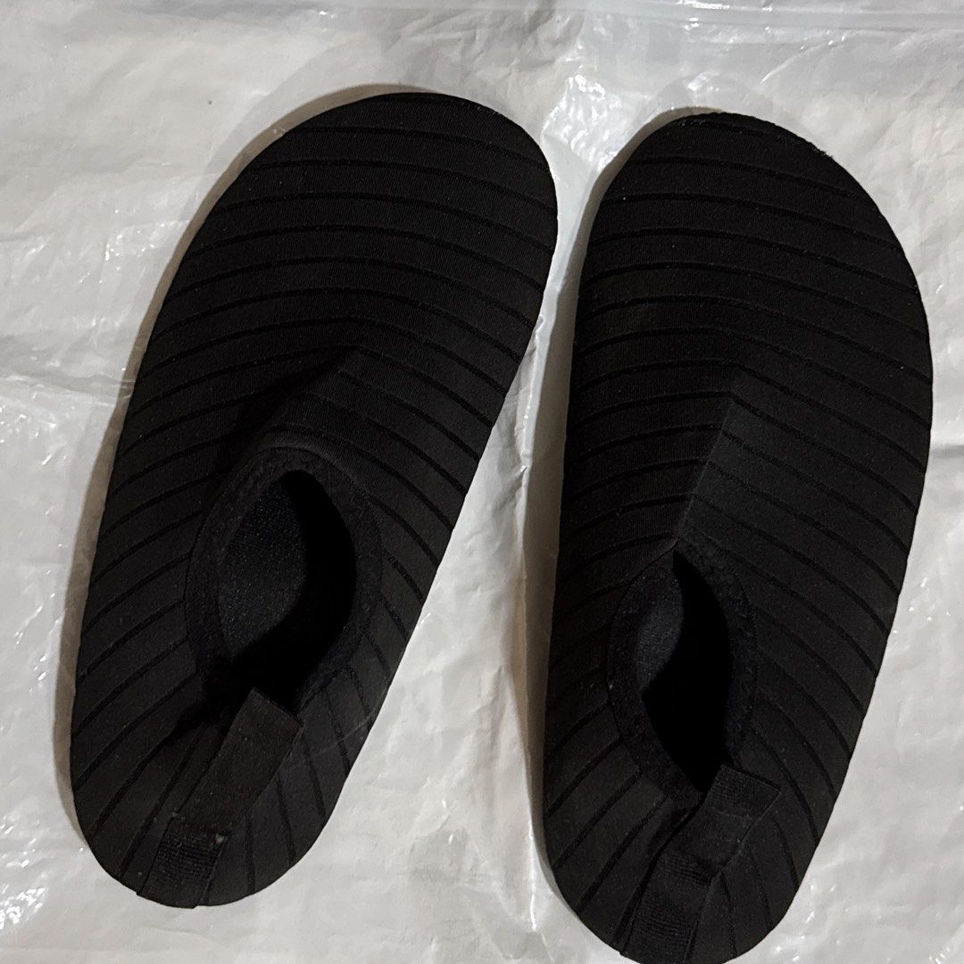 Black Swimming Shoes (Category: Slippers and slides) located in Makati City. Submitted by julyco. (Listing ID 1465360168, Image 1). Description: - Color: Black - Size: 36/37 (printed on soles) - Style: Slip-on with heel pull tabs for easy wear - Traction: Textured soles provide great grip on wet surfaces - Portability: Flexible material packs down small for travel - Best for: Beach, pool, and water sports.