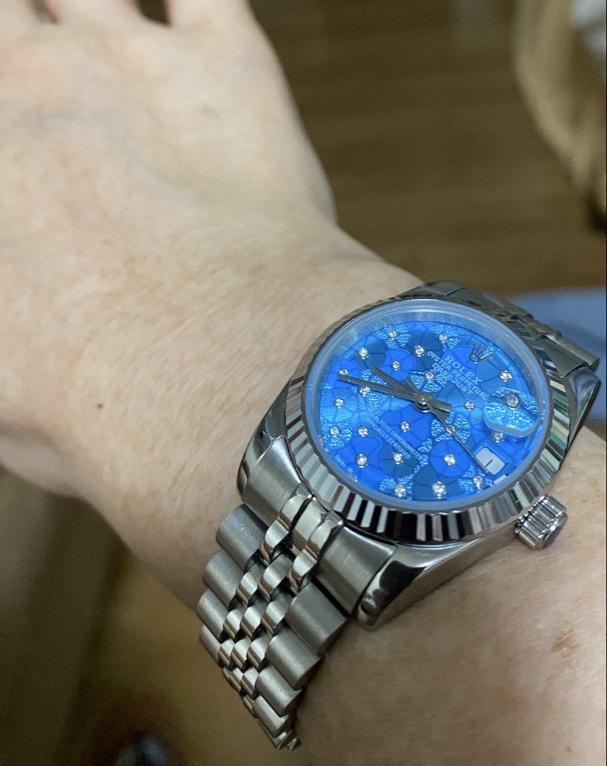 Blue Floral Dial Bracelet Watch (Category: Women's Watches) located in Makati City. Submitted by dpjanssen (Listing ID 1465290774, Image 1). Description: - Datejust watch - Stunning bright blue dial with intricate floral pattern - Sparkling crystals hour markers - fluted bezel and stainless steel bracelet - Date window with cyclops lens at 3 o'clock - Clean, polished links and smooth winding crown - Guaranteed high quality, perfect for daily wear
