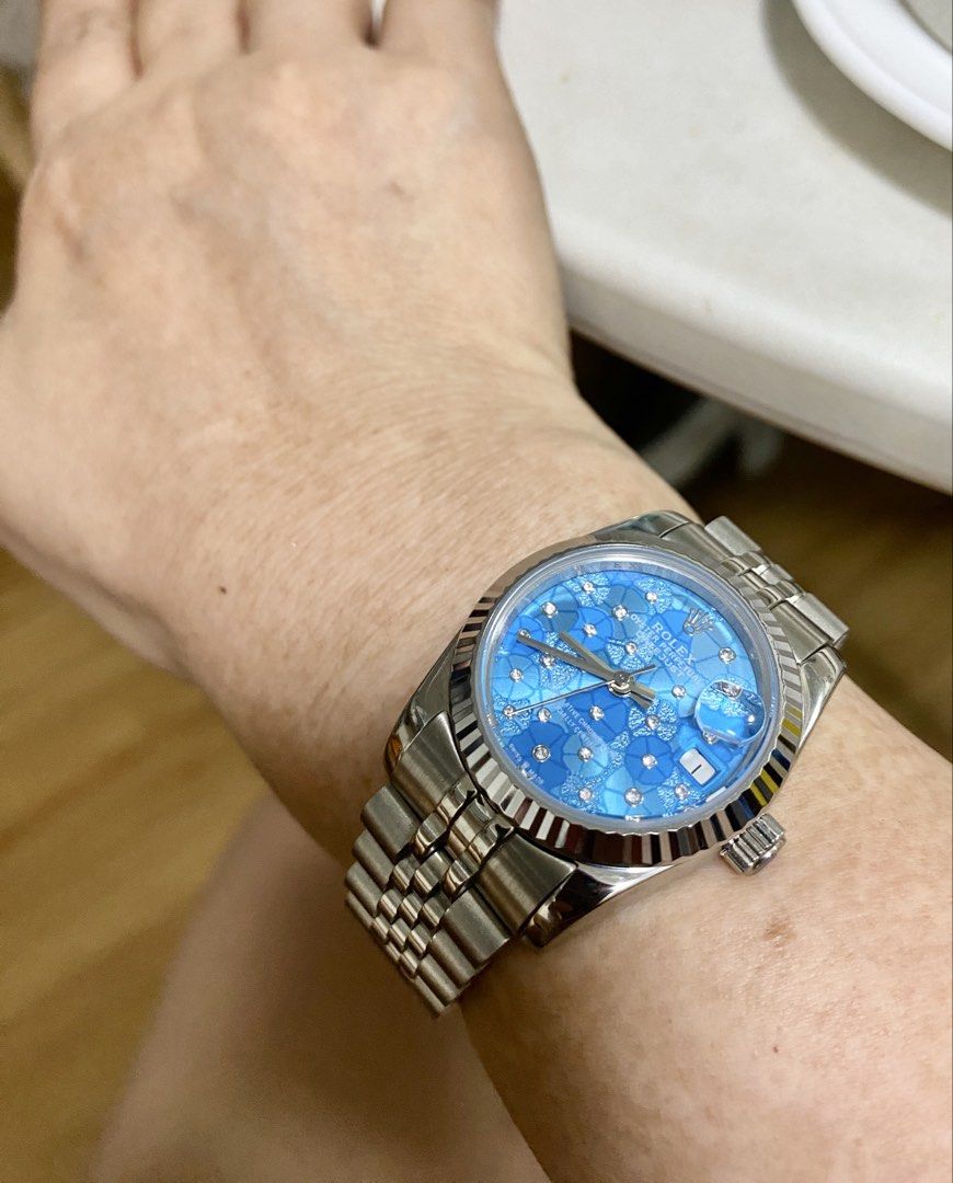 Blue Floral Dial Bracelet Watch (Category: Women's Watches) located in Makati City. Submitted by dpjanssen (Listing ID 1465290774, Image 3). Description: - Datejust watch - Stunning bright blue dial with intricate floral pattern - Sparkling crystals hour markers - fluted bezel and stainless steel bracelet - Date window with cyclops lens at 3 o'clock - Clean, polished links and smooth winding crown - Guaranteed high quality, perfect for daily wear