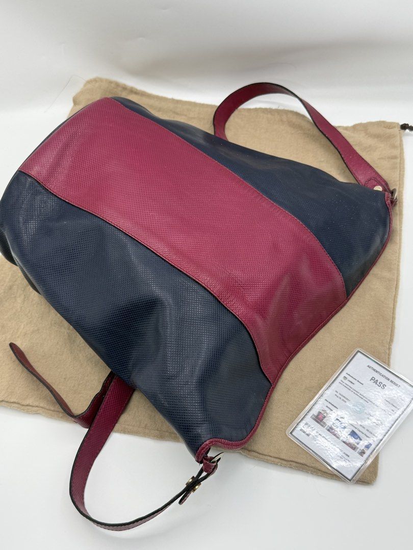 Bottega Veneta (Category: Cross-body Bags) located in Caloocan City. Submitted by rossvault2 (Listing ID 1465234758, Image 3). Description: - Authentic Bottega Veneta two-tone shoulder bag - Crafted from premium textured leather in navy and burgundy - Secure flap closure with magnetic snap - Adjustable matching burgundy leather strap - Interior zipped pocket featuring the metal 'Bottega Veneta Made in Italy' logo plaque - Includes original dust b