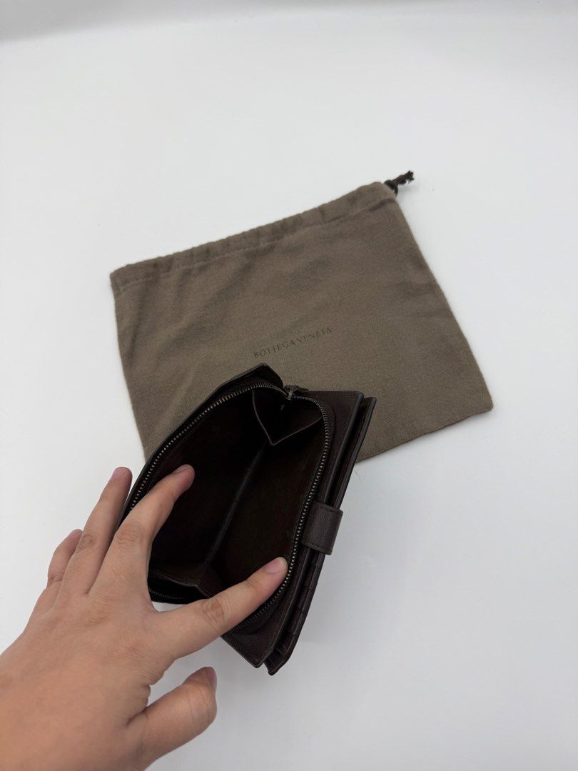 Bottega Veneta wallet (Category: Wallets & Card holders) located in Caloocan City. Submitted by rossvault2 (Listing ID 1465238493, Image 3). Description: - Bottega Veneta dark brown leather wallet - Iconic signature intrecciato weave pattern - Secure snap button closure on front flap - Organized interior with multiple card slots and zipped coin compartment - Clean condition, well-maintained inside and out - Includes original dust bag/ normal sign