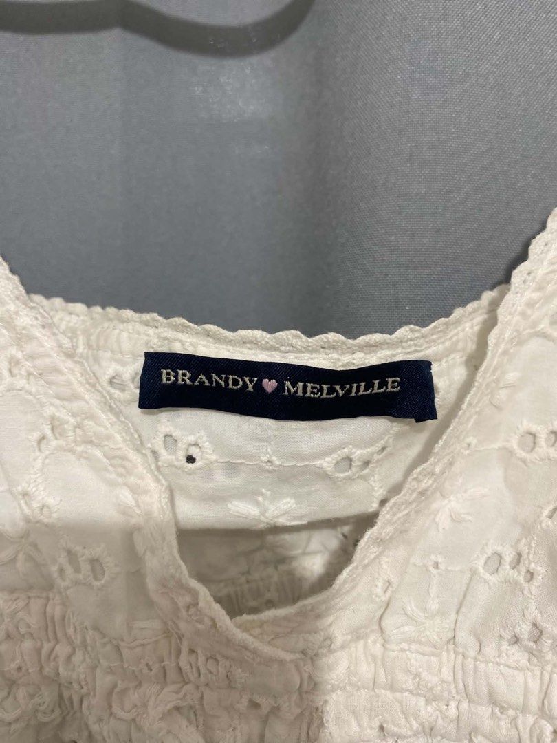 Brandy Melville White Eyelet Cami Top (Category: Sleeveless) located in Davao. Submitted by kylprdo (Listing ID 1465317445, Image 2). Description: Not thrifted - Brand: Brandy Melville - Color: White - Details: All-over eyelet embroidery, scallop V-neck trim, shirred elastic bust with center drawstring tie, thin adjustable spaghetti straps - Fit: Cropped, lightweight cotton fabric - Condition: Worn a few times, no flaws found.