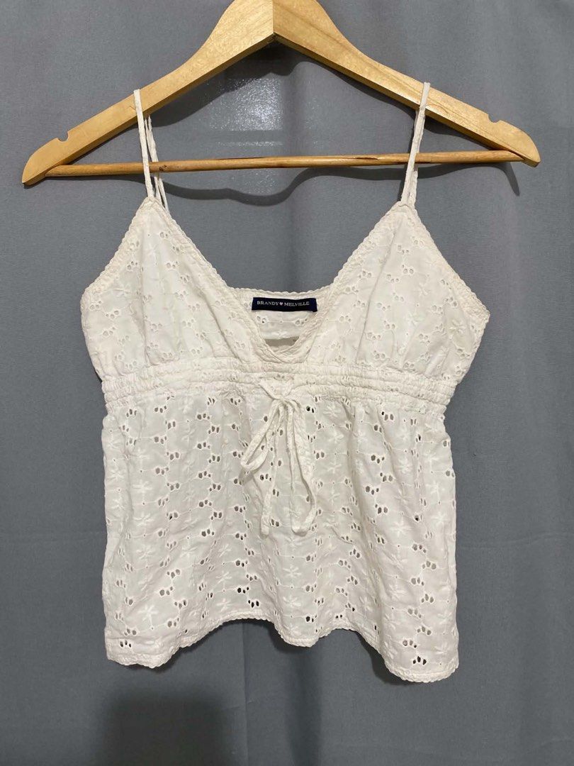 Brandy Melville White Eyelet Cami Top (Category: Sleeveless) located in Davao. Submitted by kylprdo (Listing ID 1465317445, Image 1). Description: Not thrifted - Brand: Brandy Melville - Color: White - Details: All-over eyelet embroidery, scallop V-neck trim, shirred elastic bust with center drawstring tie, thin adjustable spaghetti straps - Fit: Cropped, lightweight cotton fabric - Condition: Worn a few times, no flaws found.
