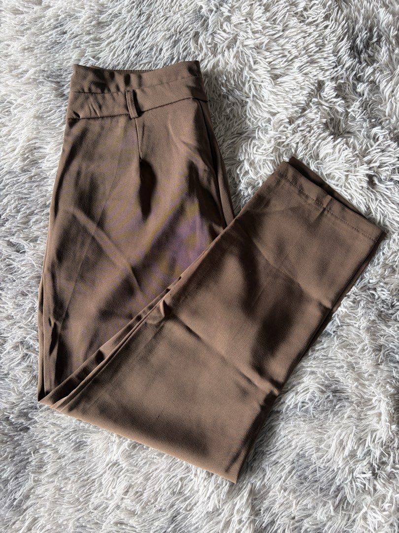 Brown High-Waisted Pleated Tailored Pants (Category: Other Bottoms) located in Manila. Submitted by kez0020 (Listing ID 1465226884, Image 3). Description: - Color: Rich brown - Waist: High-waisted with belt loops and secure zip/hook closure - Details: Front pleats, side pockets, and sharp center creases - Fit: Structured fabric with a clean hem finish - Styling: Perfect match for fitted knit tops or blazers.