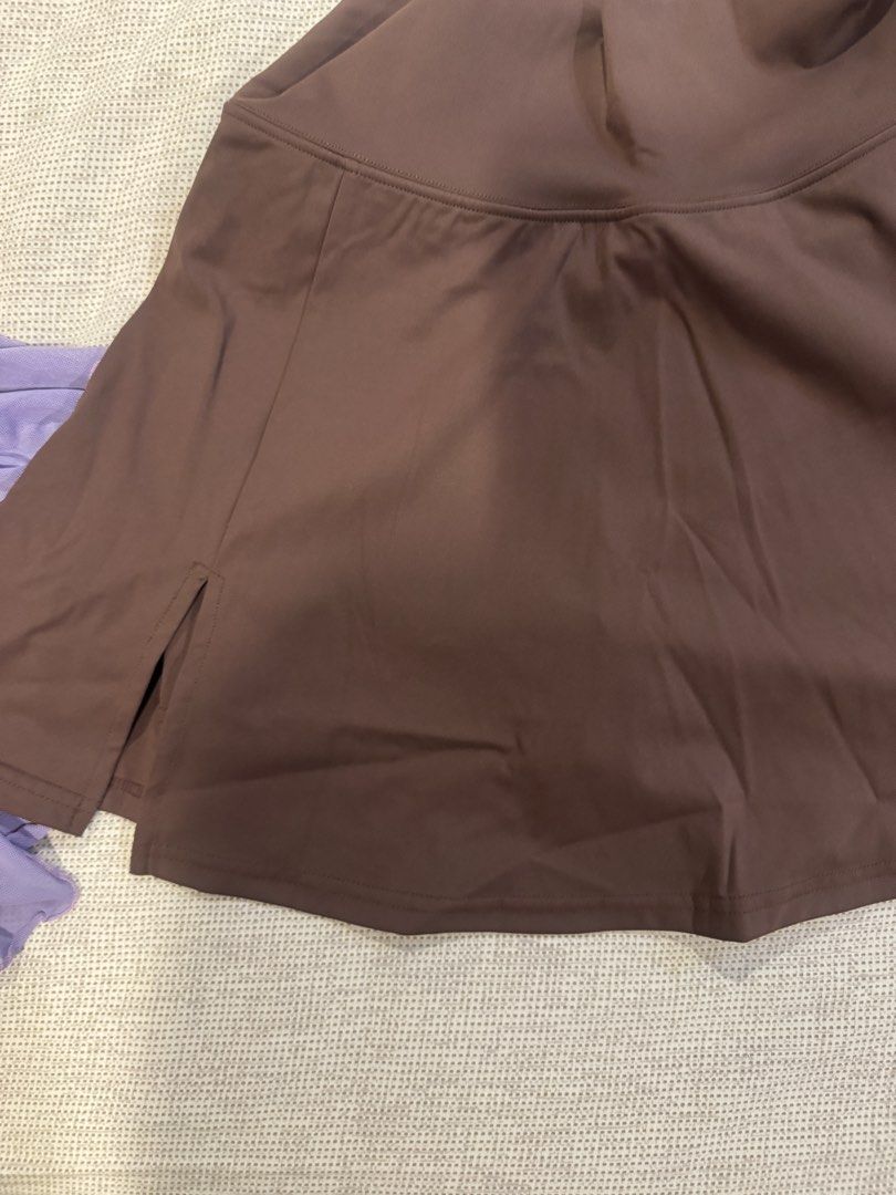 Brown Pleated Athletic Skirt Size 6 (Category: Skirts) located in Muntinlupa City. Submitted by myabcshop (Listing ID 1465196439, Image 3). Description: - Size: 6 (tag attached) - Color: Brown - Material: 75% nylon, 25% spandex (soft, stretchy, and comfortable) - Fit: High waist with built-in shorts and a cute side hem split - Ideal for: Tennis, golf, running, and workouts - Condition: Clean and excellent all around Used once / wrong size.