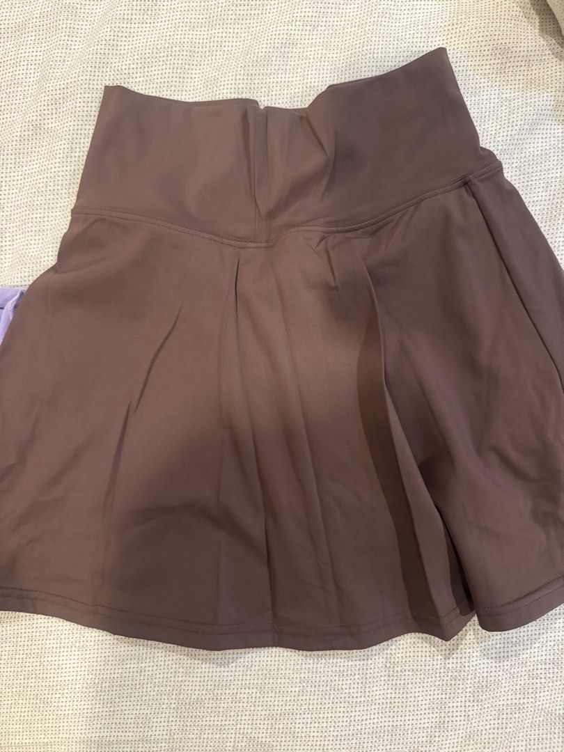 Brown Pleated Athletic Skirt Size 6 (Category: Skirts) located in Muntinlupa City. Submitted by myabcshop (Listing ID 1465196439, Image 1). Description: - Size: 6 (tag attached) - Color: Brown - Material: 75% nylon, 25% spandex (soft, stretchy, and comfortable) - Fit: High waist with built-in shorts and a cute side hem split - Ideal for: Tennis, golf, running, and workouts - Condition: Clean and excellent all around Used once / wrong size.