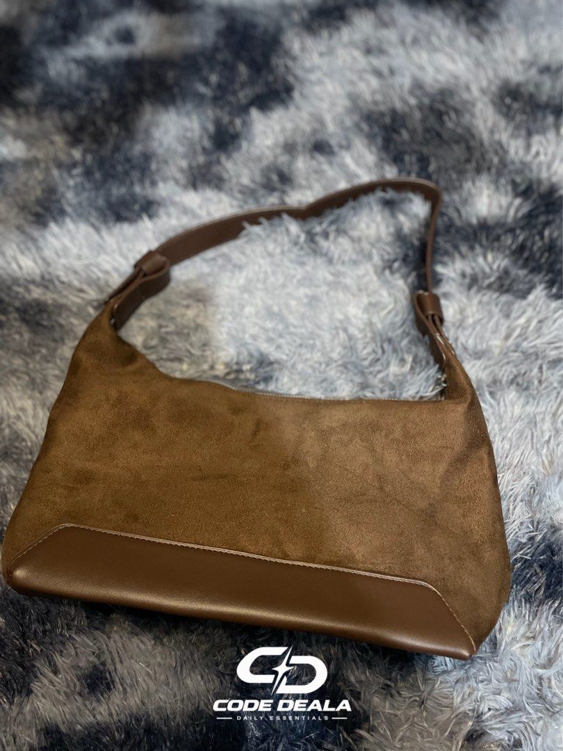 Brown Suede and Leather Shoulder Bag (Category: Shoulder Bags) located in Manila. Submitted by codedeala. (Listing ID 1465296391, Image 2). Description: - Material: Soft suede body with a durable smooth faux leather base - Color: Rich chocolate brown, perfect for autumn and winter - Closure: Secure top zipper to keep your daily essentials safe - Strap: Adjustable strap with stylish buckle detailing - Interior: Clean lining for everyday use - Size