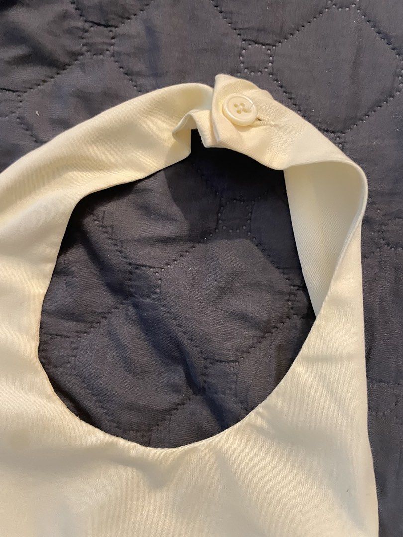 BSCO Josie Top Halter Backless Top (Category: Sleeveless) located in Manila. Submitted by finderskeepersmnl_092026 (Listing ID 1465235443, Image 2). Description: - Brand/Model: BSCO Josie Top - Color: Cream Yellow - Size: Large - Design: Halter neck with back button closure, backless cut, and flared peplum hem - Closure: Side zipper - Origin: Made in the Philippines - Occasion: Great for casual outings or parties.