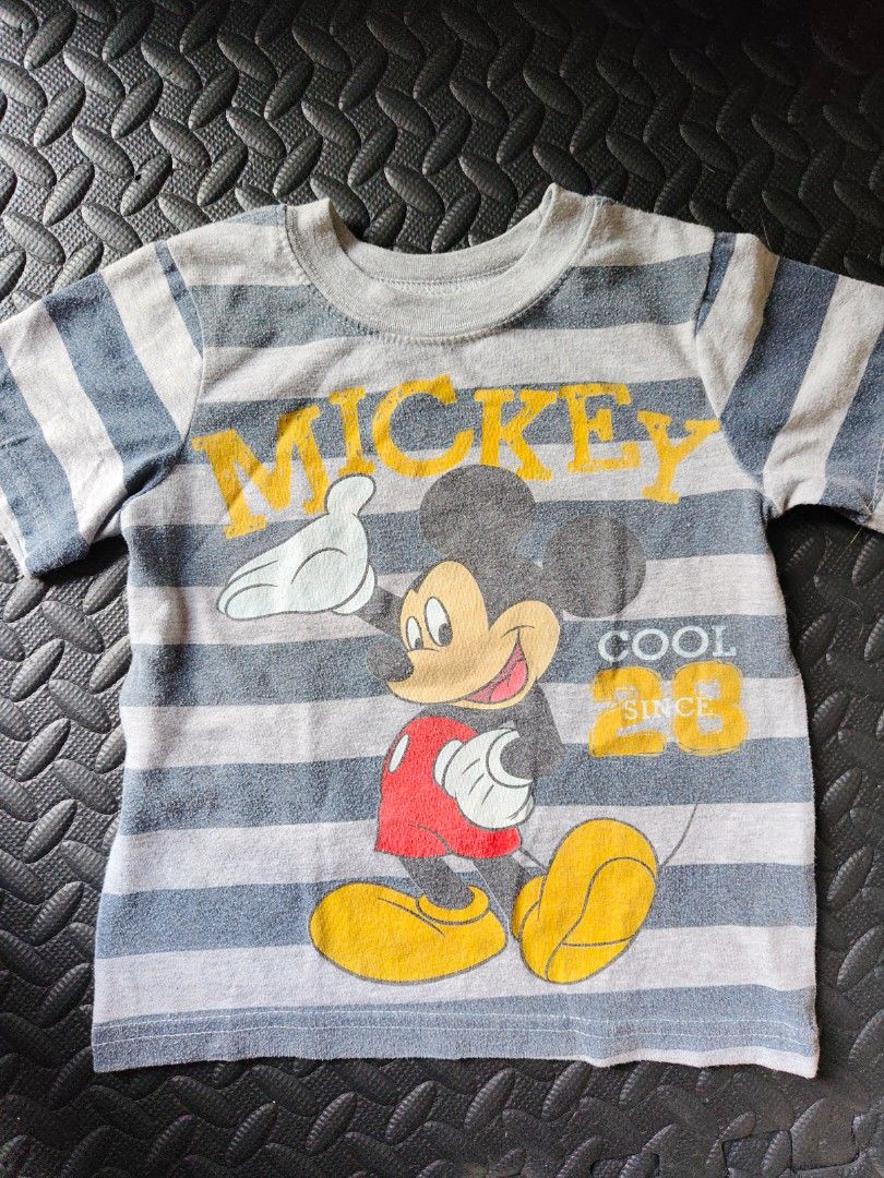 Bundle of 3 - Top (2 to 4 yrs old) (Category: Babies & Kids Fashion) located in Quezon City. Submitted by zs.onlinehub (Listing ID 1465189743, Image 1). Description: - Design: Grey and blue striped with large Mickey Mouse graphic and yellow lettering - Size: 3T (Made in Egypt) - Fit: 13 to 14 inches pit-to-pit - Condition/Use: Casual everyday top for toddlers - Deal: Feel free to message for inquiries or bundle discounts!.