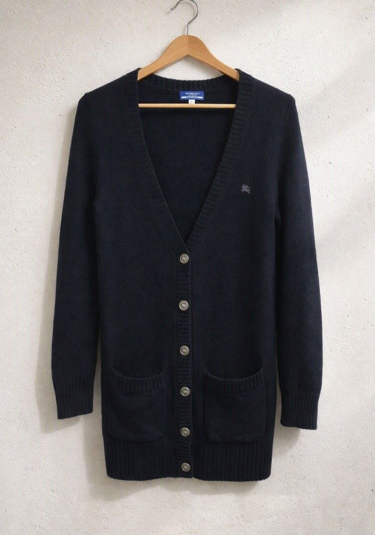 Burberry Cardigan (Category: Coats, Jackets and Outerwear) located in Baguio. Submitted by luxeloomarchive (Listing ID 1465251754, Image 1). Description: BURBERRY LONDON BLUE LABEL Italian Yarn Longline Knit Cardigan Authentic Burberry Blue Label longline cardigan crafted from a soft Italian wool blend. Features a relaxed V-neck, embroidered knight logo, crest-embossed metal buttons, and front patch pockets. Details: Material: 74% Wool, 26% Nylon