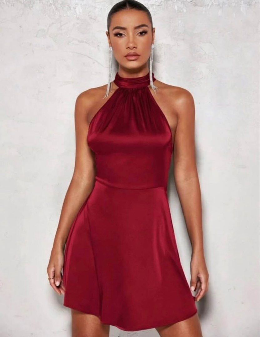 Burgundy backless dress (Category: Dresses) located in Manila. Submitted by abiareemab80400 (Listing ID 1465351081, Image 1). Description: - Color: Deep red - Material: Silky smooth satin - Style: Halter neck with high collar and dramatic open back - Skirt: Flowy pleated, above-the-knee length - Condition: Worn once for a few hours, basically spotless - Perfect for: Parties, clubbing, and nights out - Only used once - Size S/M.