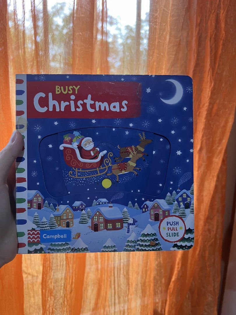 Busy Christmas Campbell Push Pull Slide Interactive Book (Category: Children's Books) located in Quezon City. Submitted by joybautista05 (Listing ID 1465253113, Image 1). Description: - Title: Busy Christmas by Campbell - Format: Sturdy board book perfect for toddlers - Features: Interactive push, pull, and slide mechanisms - Design: Bright illustrations with Santa and reindeer flying over a snowy village - Condition: Brand new / Great for giftin