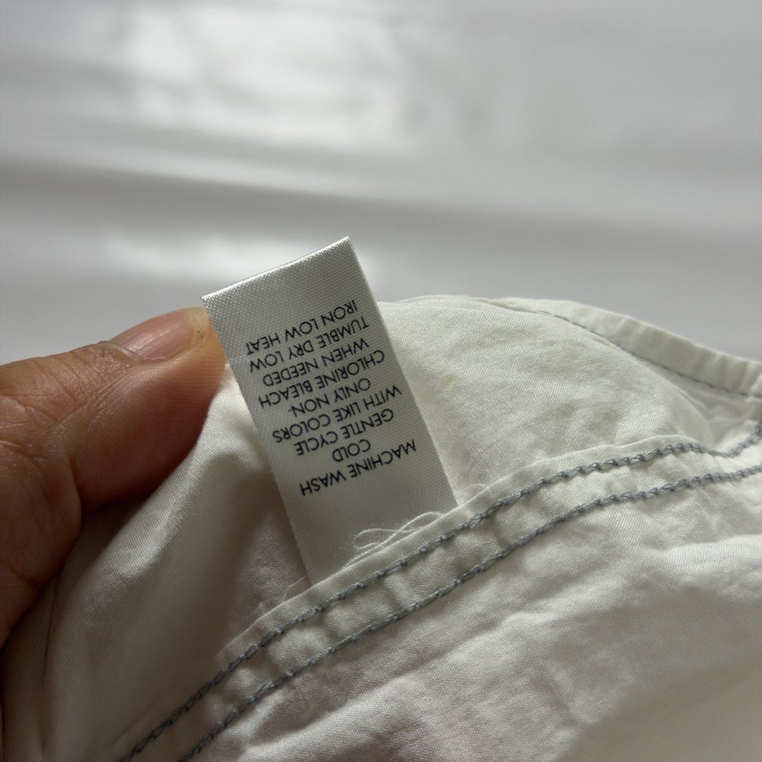Calvin Klein Graphic Short Sleeve Button Down Shirt White Medium (Category: Tshirts & Polo Shirts ) located in Manila. Submitted by johnedel_james (Listing ID 1465280906, Image 3). Description: - Brand: Calvin Klein - Size: Medium (Modern Fit) - Material: 100% Cotton - Color: White - Details: Short sleeve, branded buttons, dual chest pockets with button flaps, small chest logo, and a bold graphic print on the back - Condition: Excellent, pre-love