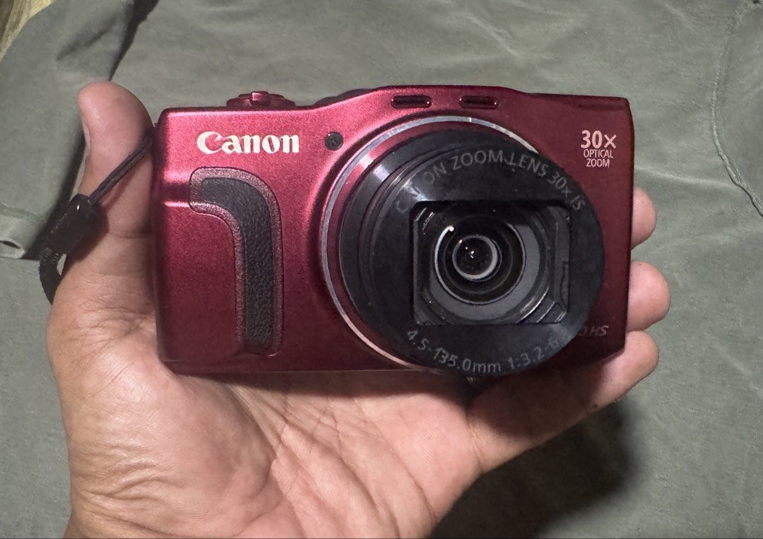 Canon PowerShot SX710 HS Red Digital Camera Bundle (Category: Cameras) located in Quezon City. Submitted by angace13 (Listing ID 1465324994, Image 2). Description: Canon PowerShot SX710 HS in striking red. 20.5 megapixels with a massive 30x optical zoom lens. Includes the original battery pack, wall battery charger, wrist strap, and a fitted black Case Logic pouch. Fully tested and working great, screen powers on clearly. Minor scuffs near the ed