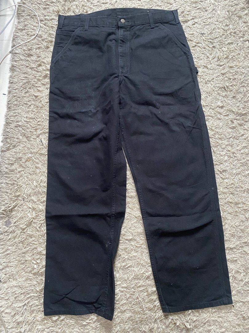 Carhartt Black Canvas Work Pants (Category: Jeans) located in Manila. Submitted by cosmicstorm.d5a9e0 (Listing ID 1465218576, Image 1). Description: - Brand: Carhartt - Color: Black - Fit: Relaxed fit - Details: Utility pockets, side hammer loop, and iconic brown logo patch on the back pocket - Material: Thick, durable canvas built for heavy labor or streetwear style.