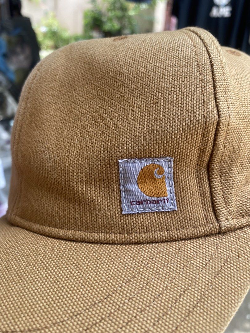 Carhbartt Brown Snapback Cap (Category: Caps & Hats) located in Talisay. Submitted by rjthriftfinds (Listing ID 1465328437, Image 3). Description: - Brand: Carhartt - Style: Canvas snapback cap - Color: Brown - Material: 100% cotton - Details: Classic woven logo patch on front, embroidered lettering above the adjustable snap closure - Interior: Taped seams with brand tags and care label - Origin: Made in China - Condition: Brand new with tags.