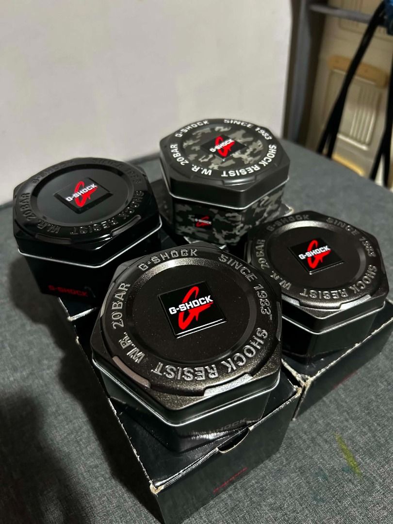 Casio G-Shock Watch Boxes Tin Containers (Category: Accessory Holder, Box & Organizers) located in Bulacan. Submitted by jseongcart_ (Listing ID 1465226924, Image 1). Description: - Authentic Casio G-Shock hexagonal metal tins with matching outer boxes - Available in sleek black and cool camouflage patterns - Includes protective foam inserts inside for safe storage - Ideal for organizing watches, accessories, or small items - SOLD AS SET ONLY - N