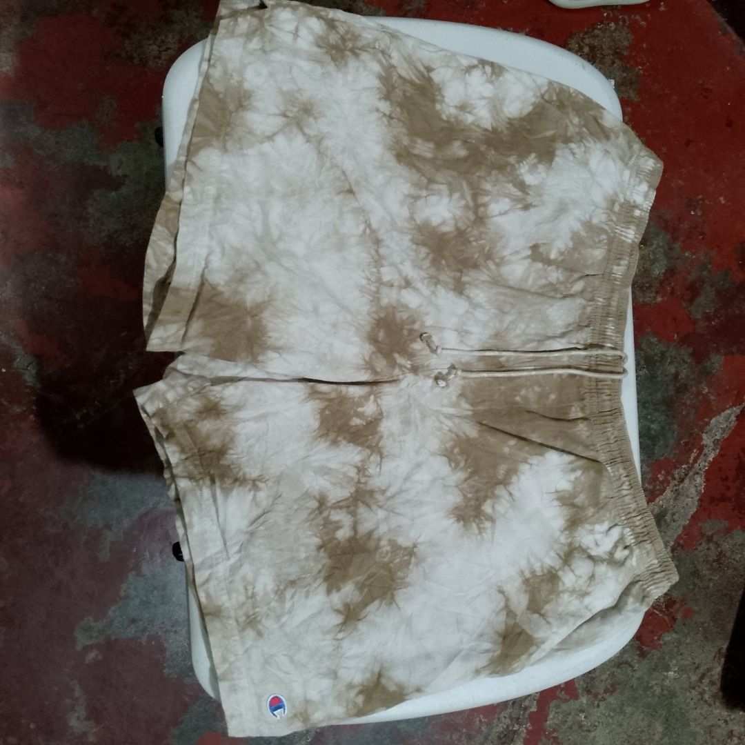 Champion Tie-Dye Brown Shorts Size L (Category: Shorts) located in Caloocan City. Submitted by raf_thrifts (Listing ID 1465289872, Image 1). Description: - Brand: Champion - Style: Shorts in a brown tie-dye pattern - Size: L - Material: 100% soft and breathable cotton - Waistband: Elastic with an adjustable drawstring - Details: Small embroidered logo on front leg hem and patch logo on back pocket - Origin: Made in Vietnam.