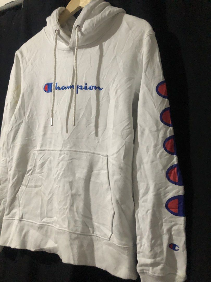 Champion White Hoodie Size Small (Category: Hoodies) located in Quezon City. Submitted by yeahsource222 (Listing ID 1465206364, Image 2). Description: - Brand: Champion - Size: Small - Color: White - Design: Classic embroidered script logo on chest and multi-logo prints on left sleeve - Features: Drawstring hood, front kangaroo pocket - Condition: Great casual piece for everyday wear, authentic tagging.