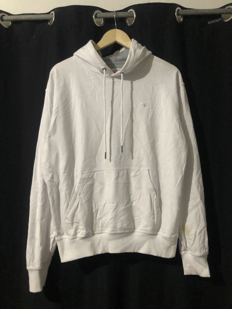 Champion White Pullover Hoodie Size M (Category: Hoodies) located in Quezon City. Submitted by yeahsource222 (Listing ID 1465206257, Image 1). Description: - Brand: Champion - Color: White - Size: Medium (true to size) - Material: 50% Cotton, 50% Polyester (Made in El Salvador) - Design: Drawstring hood, front pocket, classic embroidered logo on chest, signature patch on left wrist - Flaw: Minor yellowish stain located on the lower left sleeve ne