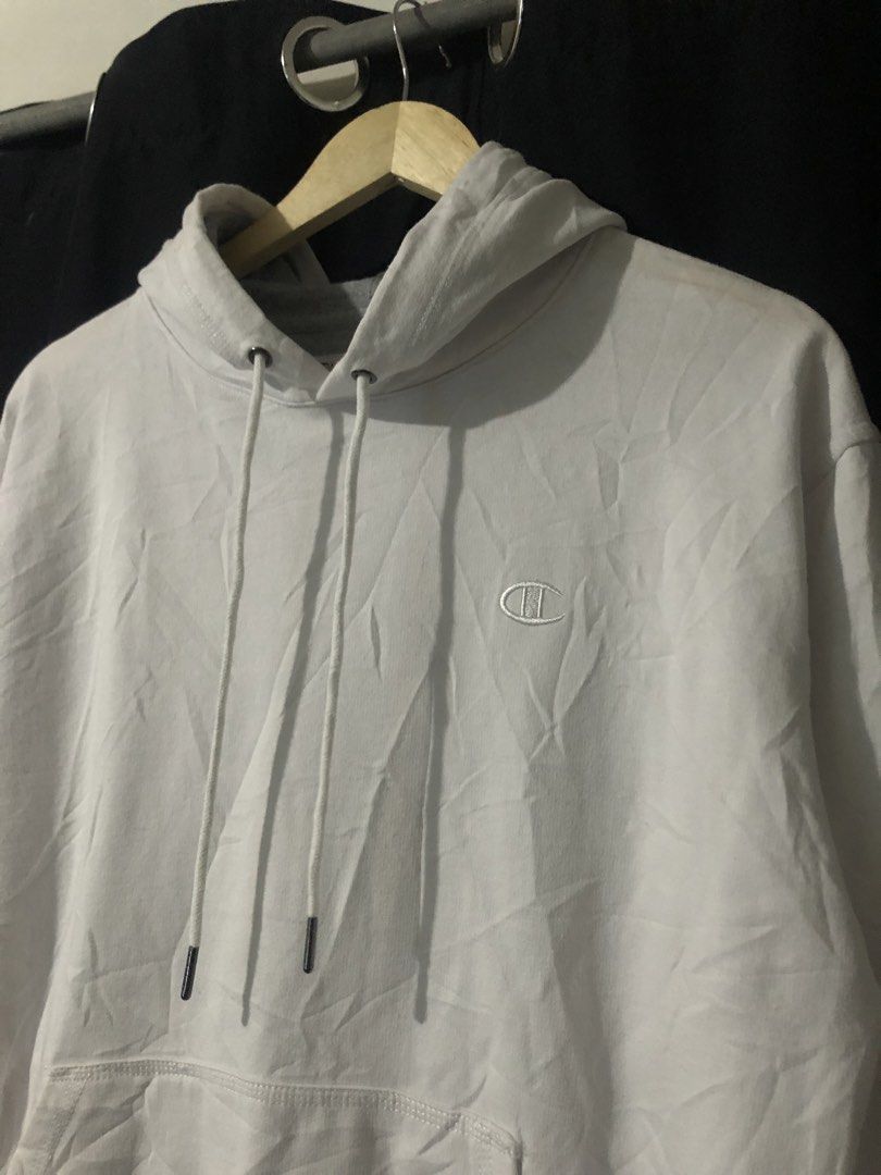 Champion White Pullover Hoodie Size M (Category: Hoodies) located in Quezon City. Submitted by yeahsource222 (Listing ID 1465206257, Image 2). Description: - Brand: Champion - Color: White - Size: Medium (true to size) - Material: 50% Cotton, 50% Polyester (Made in El Salvador) - Design: Drawstring hood, front pocket, classic embroidered logo on chest, signature patch on left wrist - Flaw: Minor yellowish stain located on the lower left sleeve ne