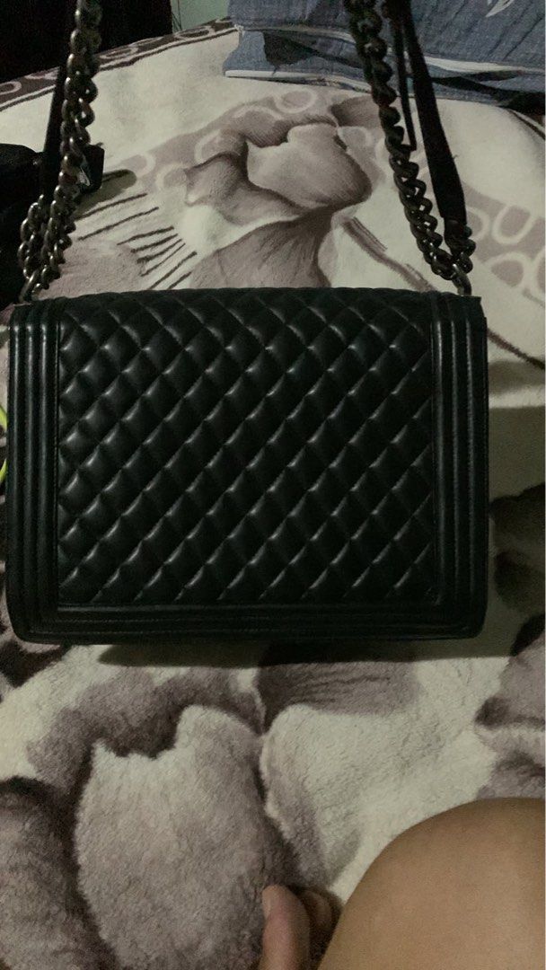 Chanel Boy Flap Bag Black Quilted Leather (Category: Luxury Bags & Wallets) located in Manila. Submitted by notjaneahe05680 (Listing ID 1465173096, Image 3). Description: - Brand: Chanel - Model: Boy Flap Bag - Material: Black quilted leather with smooth leather interior and side gussets - Hardware: Ruthenium with chunky chain strap and push-lock CC clasp - Design: Structured rectangular shape - Condition: Scuff marks on metal hardware from regul