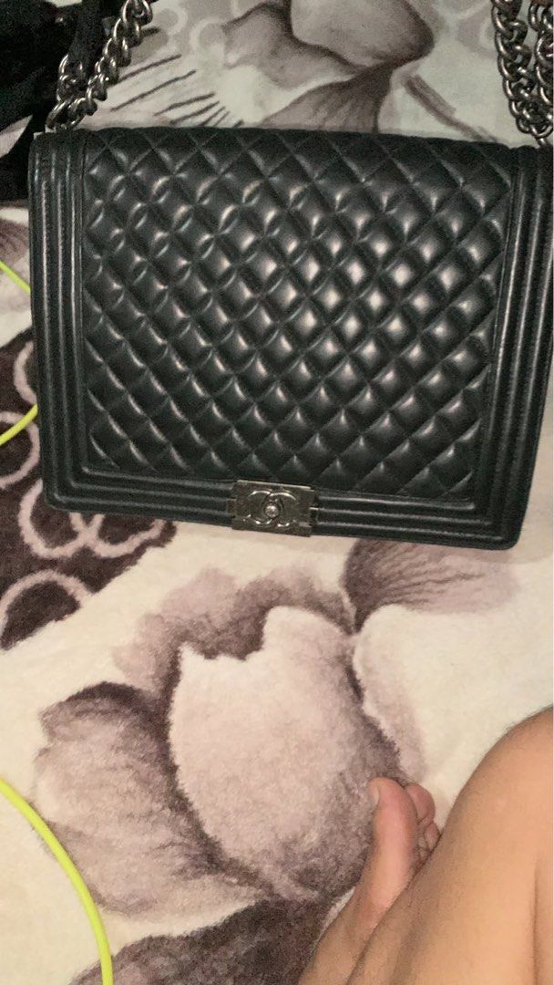 Chanel Boy Flap Bag Black Quilted Leather (Category: Luxury Bags & Wallets) located in Manila. Submitted by notjaneahe05680 (Listing ID 1465173096, Image 1). Description: - Brand: Chanel - Model: Boy Flap Bag - Material: Black quilted leather with smooth leather interior and side gussets - Hardware: Ruthenium with chunky chain strap and push-lock CC clasp - Design: Structured rectangular shape - Condition: Scuff marks on metal hardware from regul