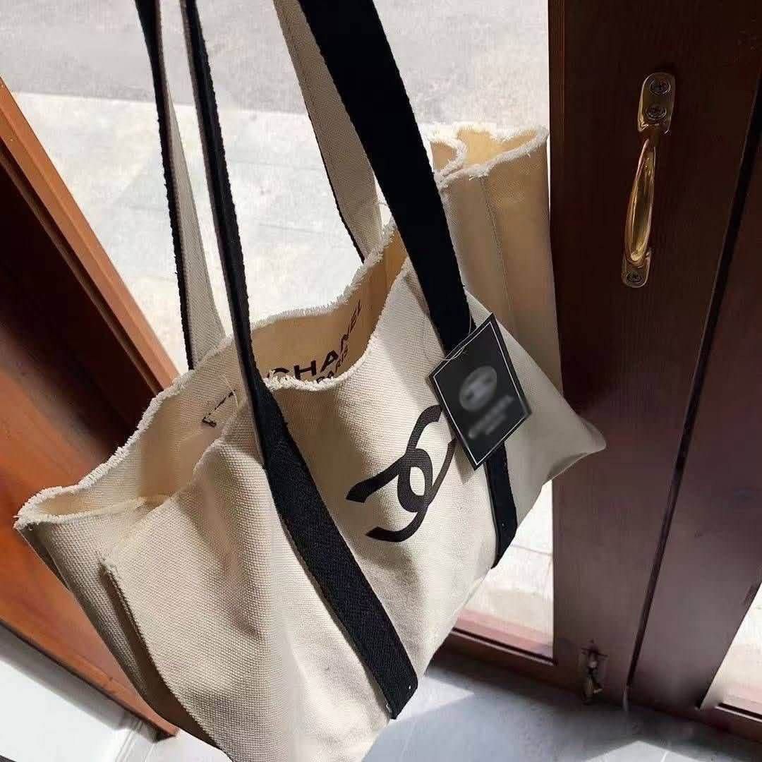 Chanel Canvas Tote Bag (Category: Tote Bags) located in Taytay. Submitted by angeltyyyy (Listing ID 1465260330, Image 2). Description: selling this authentic complimentary gift from Chanel ✨ tote bag with the iconic Chanel logo at the front, personally bet ko yung frayed edges design nya 🫶🏻 perfect for errands and everyday use! arriving mid Oct ✨ loc: taytay, rizal (can also ship from QC and Pasay, depending on sched 💗).
