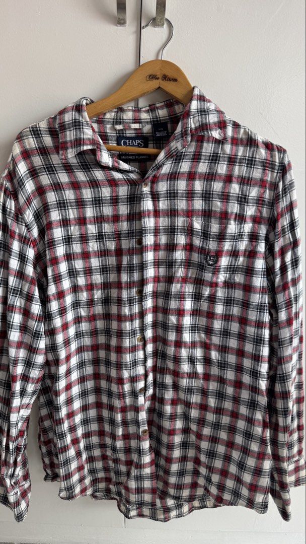 Chaps Brushed Flannel Plaid Shirt Size L (Category: Tshirts & Polo Shirts ) located in Quezon City. Submitted by meezck (Listing ID 1465187617, Image 1). Description: - Brand: Chaps - Style: Brushed flannel button-down shirt - Color/Pattern: Red, black, and white plaid - Size: L (Tag on collar) - Material: 100% Cotton, Made in India - Features: Single chest pocket with small embroidered logo, standard collar, long sleeves - Condition: Excellent p
