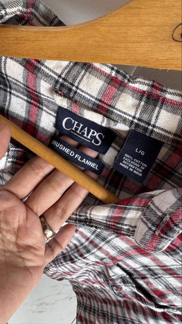 Chaps Brushed Flannel Plaid Shirt Size L (Category: Tshirts & Polo Shirts ) located in Quezon City. Submitted by meezck (Listing ID 1465187617, Image 2). Description: - Brand: Chaps - Style: Brushed flannel button-down shirt - Color/Pattern: Red, black, and white plaid - Size: L (Tag on collar) - Material: 100% Cotton, Made in India - Features: Single chest pocket with small embroidered logo, standard collar, long sleeves - Condition: Excellent p
