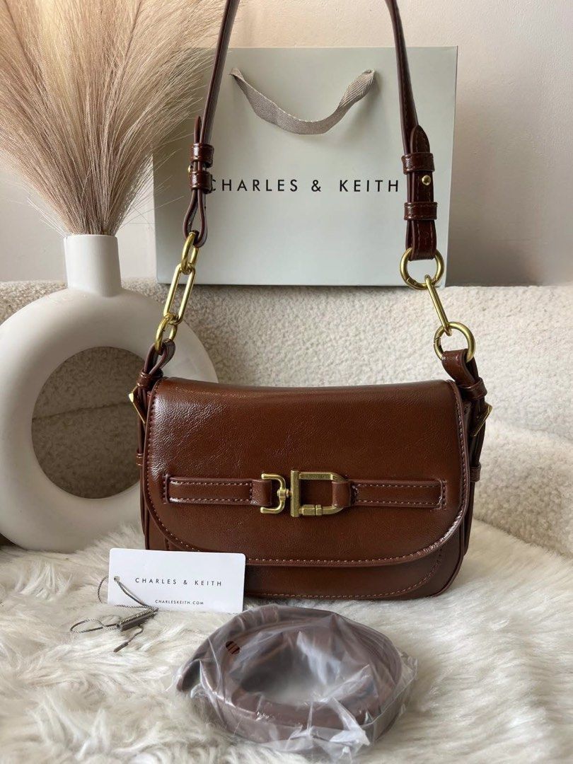 Charles & Keith Chain Shoulder Bag- Brown (Category: Shoulder Bags) located in Pasig City. Submitted by preloved.closet2 (Listing ID 1465378703, Image 1). Description: 2way Bag With Sling Size 8 inches Color Brown Add paperbag plus 80 .
