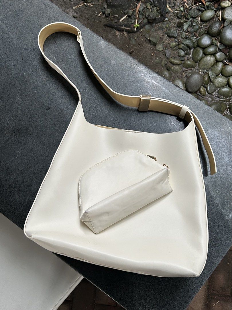 Charles & Keith Off-white shoulder bag with matching pouch (Category: Shoulder Bags) located in Quezon City. Submitted by javi_agbayani (Listing ID 1465221493, Image 1). Description: - Color/Material: Off-white faux leather with contrast beige lining and stitching - Style: Versatile everyday shoulder bag with gold-tone metal hardware and adjustable strap - Includes: A matching small pouch with zip closure - Interior: Unlined with clean contrast d