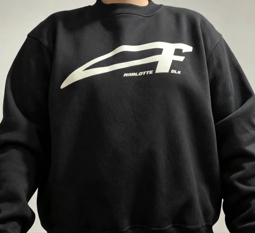 Charlotte Folk Black Sweatshirt (Category: Coats, Jackets and Outerwear) located in Manila. Submitted by candaceoin04943 (Listing ID 1465274630, Image 2). Description: - Brand: Charlotte Folk - Size: Medium (True to size) - Color: Black with large white chest logo - Material: Thick cotton fleece, super warm and cozy - Details: Classic ribbed collar, cuffs, and hem - Style: Minimalist streetwear, perfect to pair with cargo pants or denim.