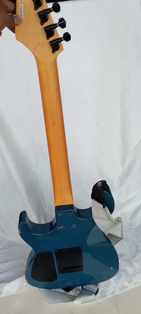Chatting Bird by Caparison Electric Guitar Blue (Category: Musical Instruments) located in Quezon City. Submitted by jpnvintageonline (Listing ID 1465269825, Image 3). Description: - Brand/Model: Chatting Bird by Caparison Electric Guitar - Finish: Metallic Blue with matching headstock aesthetic - Pickups & Controls: Versatile HSS configuration with volume and tone knobs - Neck & Fretboard: Rosewood fretboard featuring classic dot inlays and blac