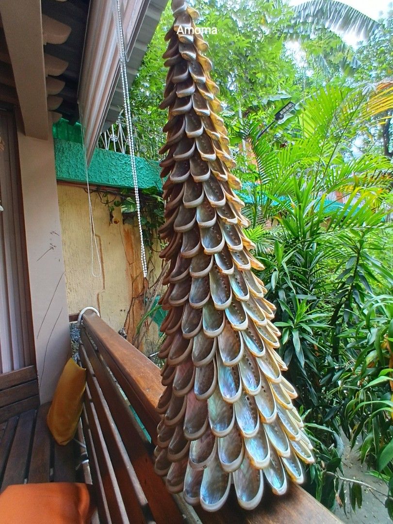 Christmas tree Abalone Shell Decor Cone Sculpture (Category: Vases & Decorative Bowls) located in Taguig. Submitted by amomaenterprise (Listing ID 1465216508, Image 2). Description: - Material: 100% genuine overlapping abalone shells - Design: Cone-shaped decorative statement piece - Finish: Natural iridescent shine with green, purple, and silver tones - Build: Heavy and solid structure - Size: Roughly two feet long - Perfect for: Tabletop, shelf