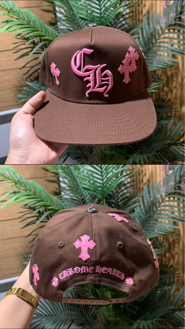 Chrome Hearts Brown Pink Hat Cap (Category: Caps & Hats) located in Butuan. Submitted by nielben13 (Listing ID 1465182984, Image 1). Description: - Brand: Chrome Hearts - Color: Brown with pink embroidery details - Design: Large CH monogram on front, cross patches on sides and back, and lettering above the strap - Hardware: Silver button on top - Structure: Clean fabric with structured panels - Closure: Adjustable snapback - Condition: Excellent,