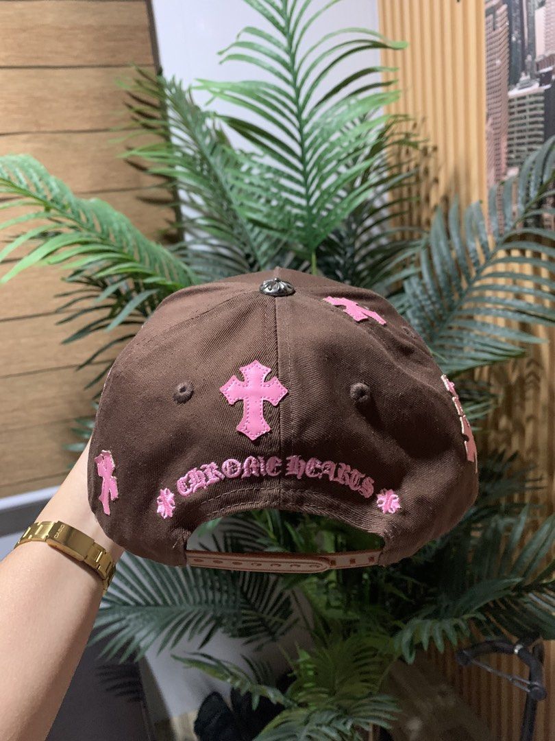 Chrome Hearts Brown Pink Hat Cap (Category: Caps & Hats) located in Butuan. Submitted by nielben13 (Listing ID 1465182984, Image 3). Description: - Brand: Chrome Hearts - Color: Brown with pink embroidery details - Design: Large CH monogram on front, cross patches on sides and back, and lettering above the strap - Hardware: Silver button on top - Structure: Clean fabric with structured panels - Closure: Adjustable snapback - Condition: Excellent,