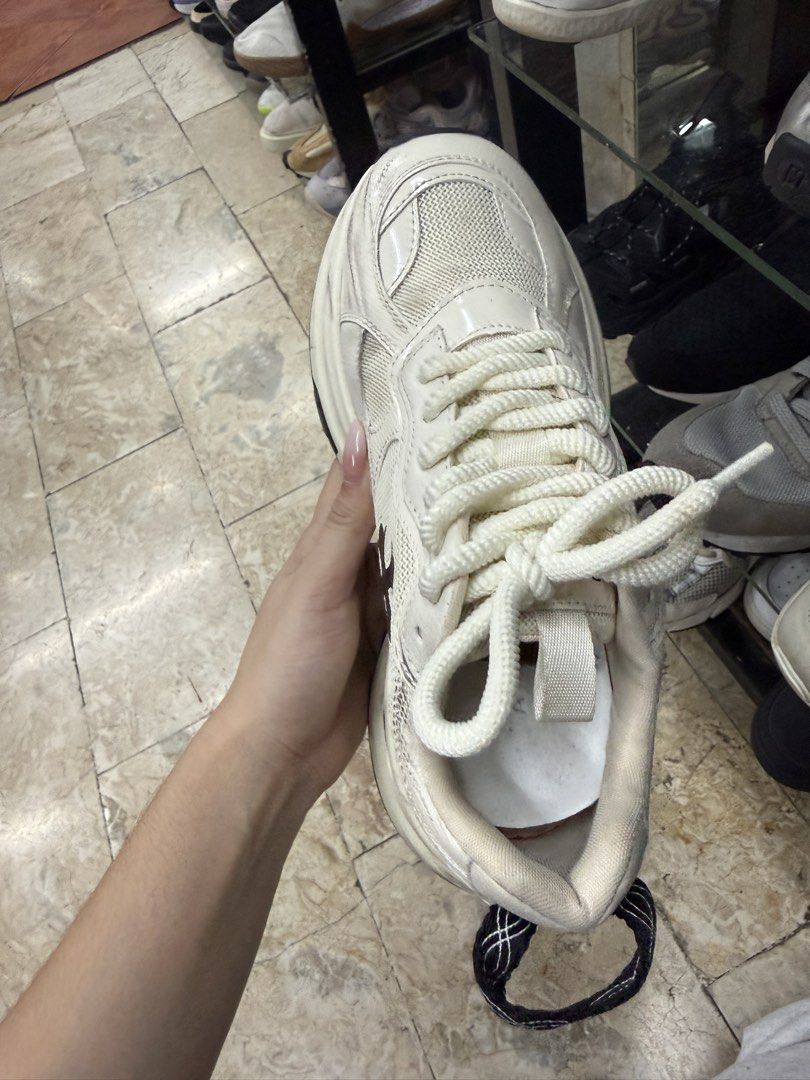 Chunky Platform Sneakers White Black Cross Logo (Category: Sneakers) located in Abucay. Submitted by fastlion.584bdf (Listing ID 1465360455, Image 2). Description: - Color: White with contrasting black cross logo - Style: Thick platform sneakers with chunky, heavy-tread rubber sole - Details: White rope laces and black heel pull tab - Condition: Pre-owned, with noticeable scuffs/wear on the white midsole and heel counter, and dirt on the soles - 