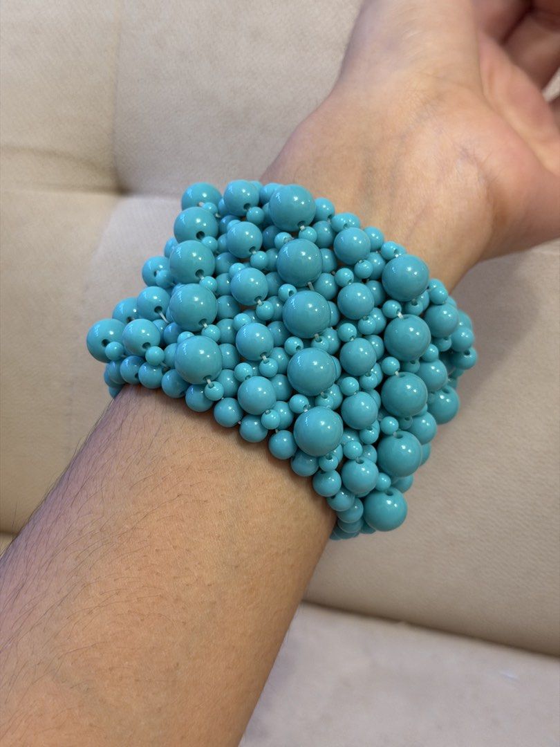 Chunky Turquoise Blue Beaded Statement Cuff Bracelet (Category: Bracelets) located in Pasig City. Submitted by miss_abuelita (Listing ID 1465261351, Image 2). Description: Bold multi-strand cuff bracelet made of glossy turquoise blue beads in various sizes. Wide design covers a good portion of the wrist. Stretchable construction fits comfortably without clasp hardware. Vibrant pop of color for casual outfits or summer wear. Lightweight plastic ma