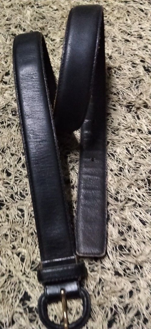 Classic black leather belt with round buckle (Category: Belts) located in Paranaque City. Submitted by michael-08 (Listing ID 1465206693, Image 1). Description: - Color: Classic black with visible texture - Buckle: Round leather-wrapped design with gold-tone metal prong - Details: Matching leather keeper loop and sturdy edge stitching - Fit: Multiple punched holes for adjustable sizing - Style: Versatile and sturdy, ideal for daily wear with jean