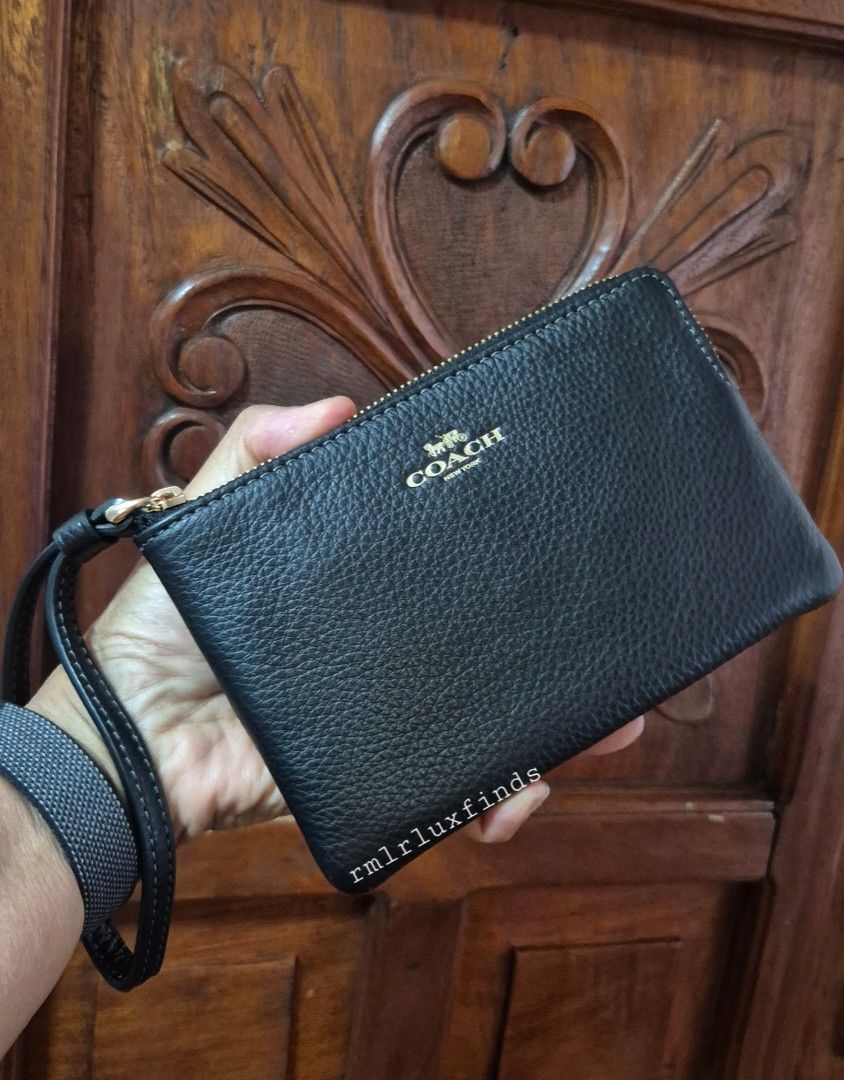 Coach Corner SIngle Zip Black Pebbled Leather Wristlet🇺🇲Authentic (Category: Luxury Bags & Wallets) located in Quezon City. Submitted by rmlrluxfinds (Listing ID 1413866484, Image 1). Description: ** brandnew, sealed and authentic ** measures 6.25"L x 4"H x 0.5"W ** refined pebble leather ** fabric lining ** wrist strap attached ** 2 credit card slots ** zip-top closure ON HAND and ready to ahip ✅️tag ✅️carecard rmlrluxfinds is not associated o