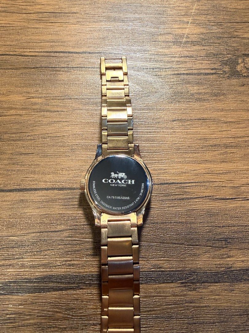Coach Gold Quartz Watch (Category: Women's Watches) located in Makati City. Submitted by lucy_dec (Listing ID 1465275347, Image 3). Description: - Brand: Coach - Color: Gold - Model: CA.79.7.95.1201S - Features: Crystal-embellished bezel, iconic C monogram dial, and link bracelet strap - Caseback: Stainless steel - Size: 37mm - Inclusions: Original white fabric dust pouch with Coach logo print - Condition: Excellent / Well-maintained - Mode of Pa