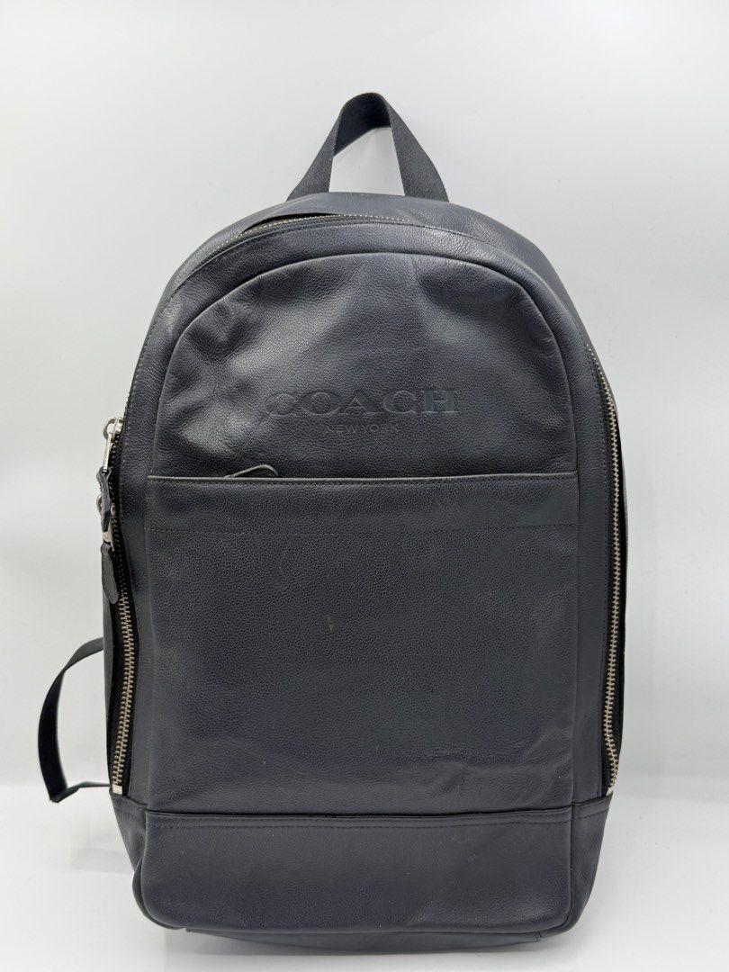 Coach New York Black Leather Backpack (Category: Backpacks) located in Caloocan City. Submitted by rossvault2 (Listing ID 1465227524, Image 1). Description: - Authentic Coach New York black leather backpack - Embossed front logo with front zip pocket and chunky side zippers - Breathable mesh back panel for added comfort - Padded leather shoulder straps with adjustable nylon webbing and top grab handle - Condition: Shows regular wear on the leathe