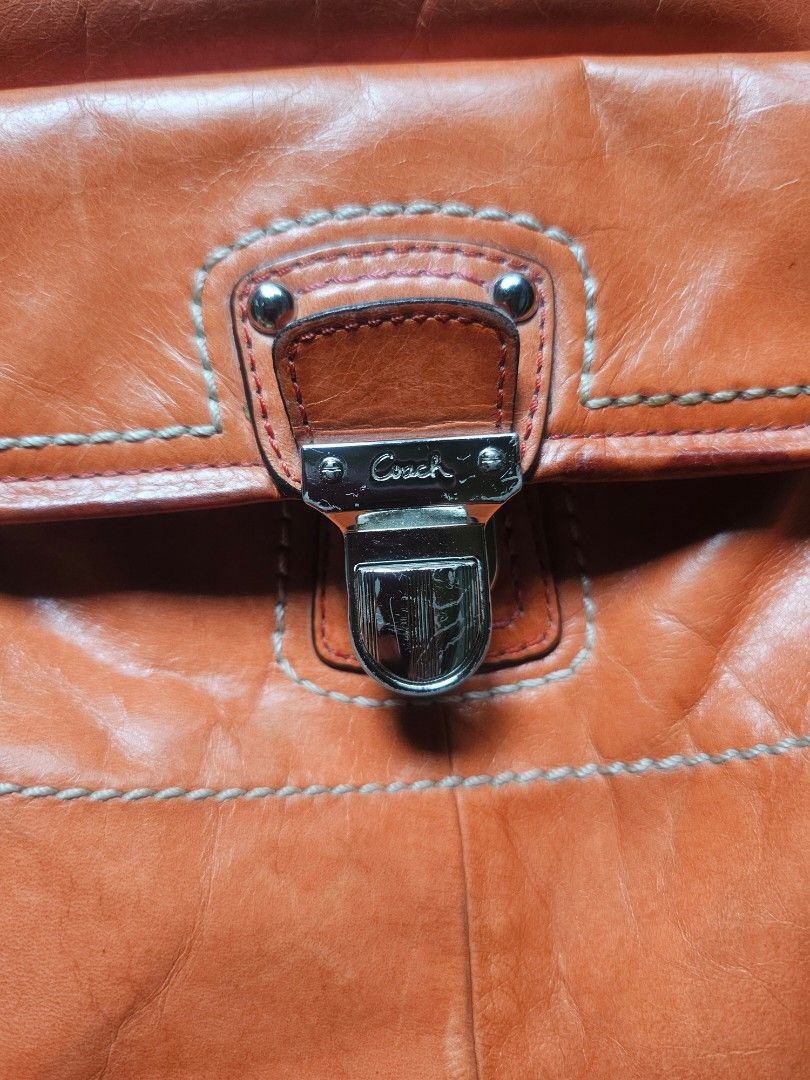 Coach Orange Leather Tote Shoulder Bag (Category: Luxury Bags & Wallets) located in Marikina City. Submitted by charmaine185845 (Listing ID 1465335274, Image 3). Description: - Brand: Coach - Color: Bright orange with contrast white stitching - Material: Soft, slouchy leather - Hardware: Silver-tone with front flap turn-lock closure, rings, and studs - Straps: Dual top carry handles and a detachable long shoulder strap - Interior: Clean setup, id